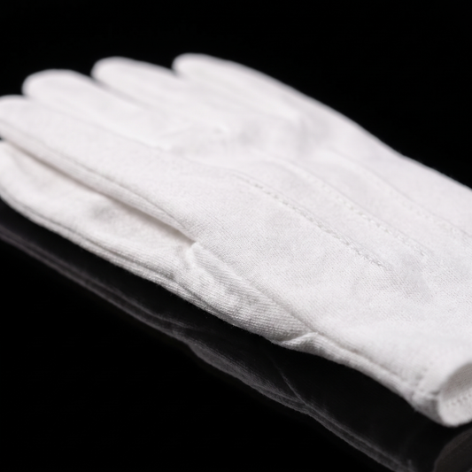 47VAULT Collector Gloves, angled detail on black showing the cotton weave of the coin handling gloves