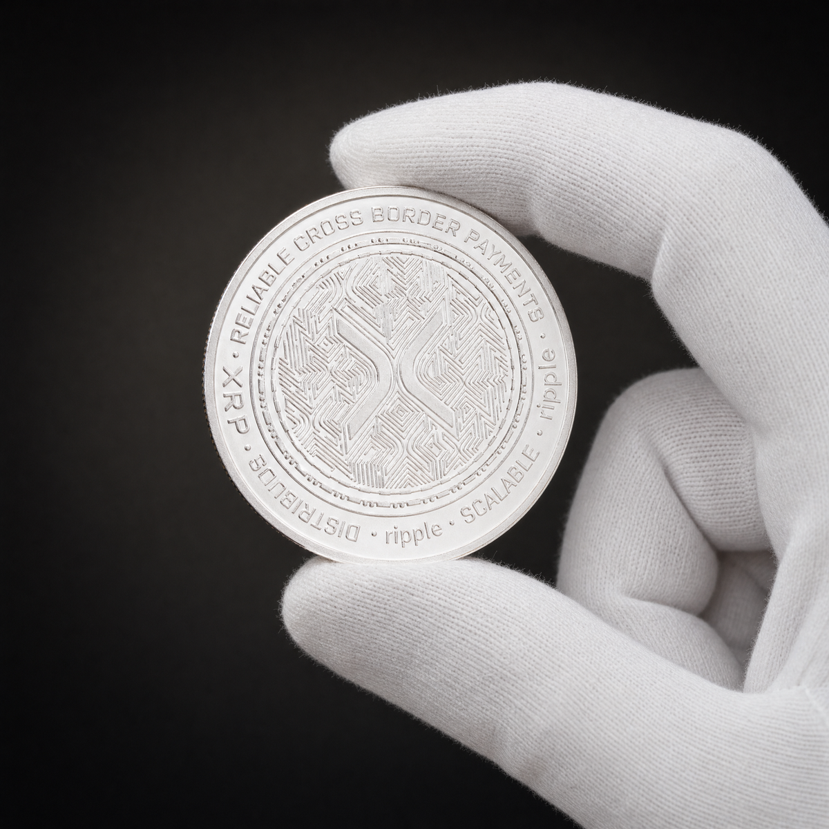 Liberty Coin Aurora Edition held in a white cotton conservator glove, obverse toward the camera