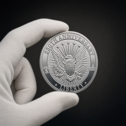 Liberty 250 Coin Legacy Edition held in a white cotton conservator glove, reverse toward the camera