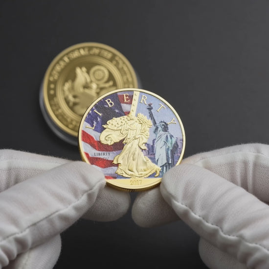 Liberty Coin Union Crest Edition held in white cotton conservator gloves, colourised face toward camera