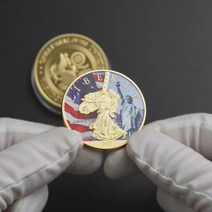Liberty Coin Union Crest Edition held in white cotton conservator gloves, colourised face toward camera