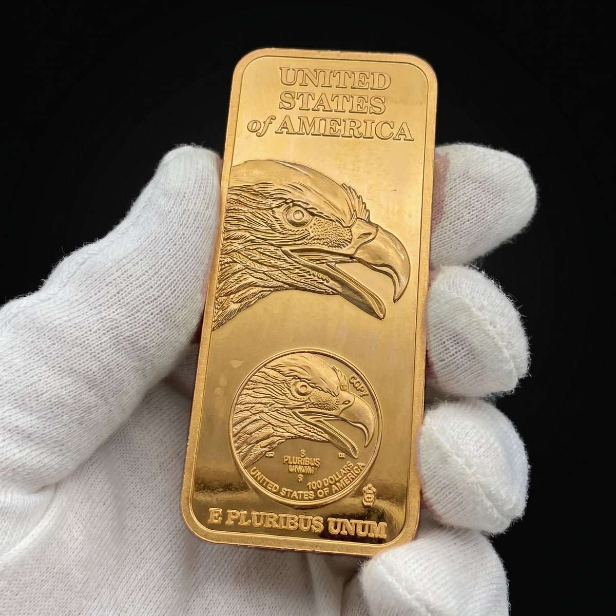 Liberty Bar Sentinel Edition held in white cotton conservator gloves, the eagle head face toward the camera
